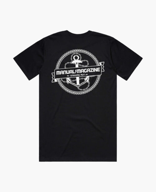 A product photo of the Manual Staying Put t-shirt in black. Showing the back print.