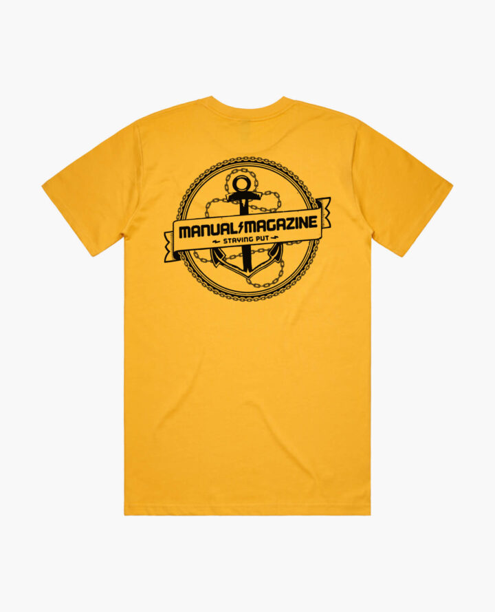 A product photo of the Manual Staying Put t-shirt in yellow. Showing the back print.