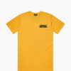 A product photo of the Manual Staying Put t-shirt in yellow. Showing the front print.
