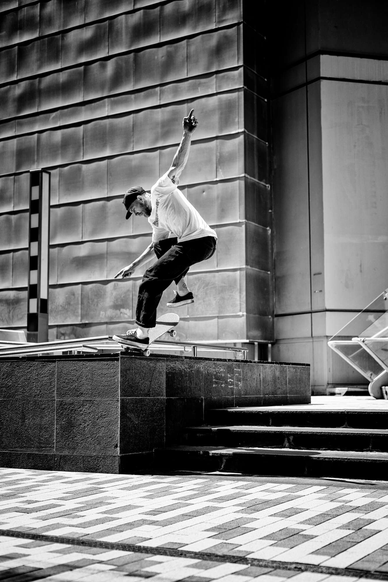 Beacho, pop-shuvit nosegrind, Aotea Square, Auckland. Photo by Kingsley Attwood.