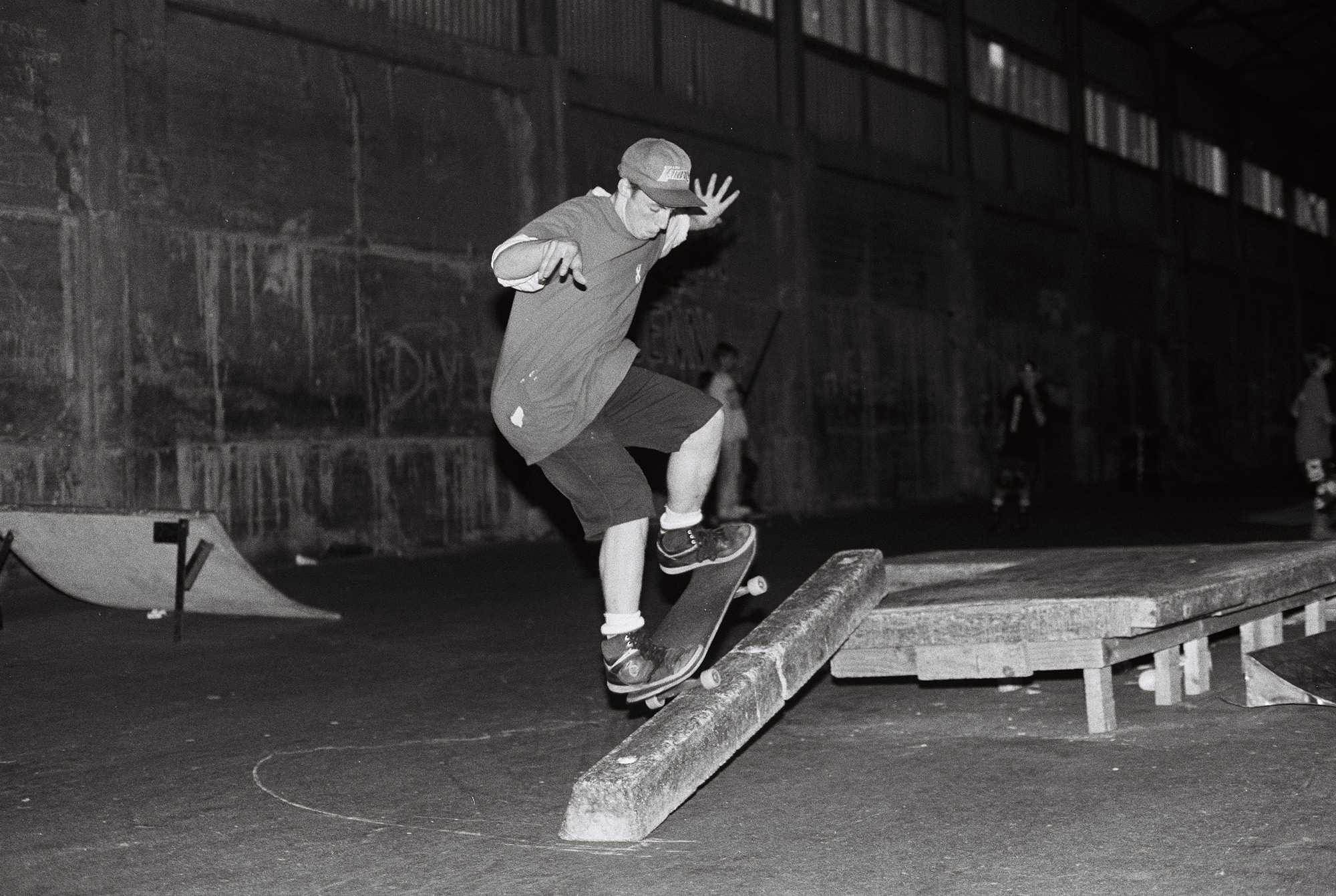 Ivan Gregoroff performing a frontside nosegrind on a parking block ledge at The Skate Pit in Wellington, 1990.