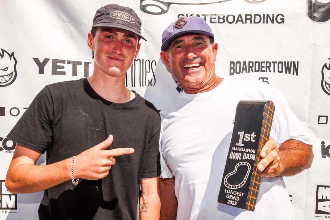 Dave Crabb presents Keefer Wilson with the longest grind award for his frontside 50-50 around the shallow end.